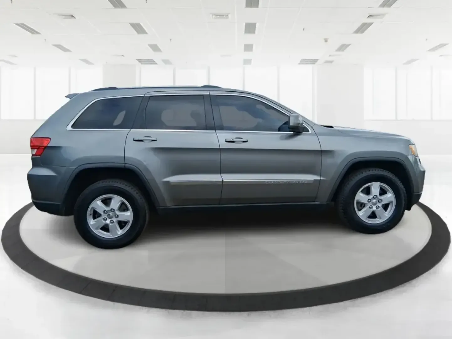 2013 Jeep Grand Cherokee Laredo (1C4RJFAG1DC) with an 3.6L V6 DOHC 24V engine, 5-Speed Automatic transmission, located at 401 Woodman Dr, Riverside, OH, 45431, (937) 908-9800, 39.760899, -84.123421 - Pack up the family, point the hood toward the next weekend getaway, and enjoy the confidence that comes with a capable SUV built for real life in Ohio. This 2013 Jeep Grand Cherokee Laredo in Mineral Gray Metallic Clearcoat is the kind of vehicle that fits your routine Monday through Friday-then tur - Photo#1