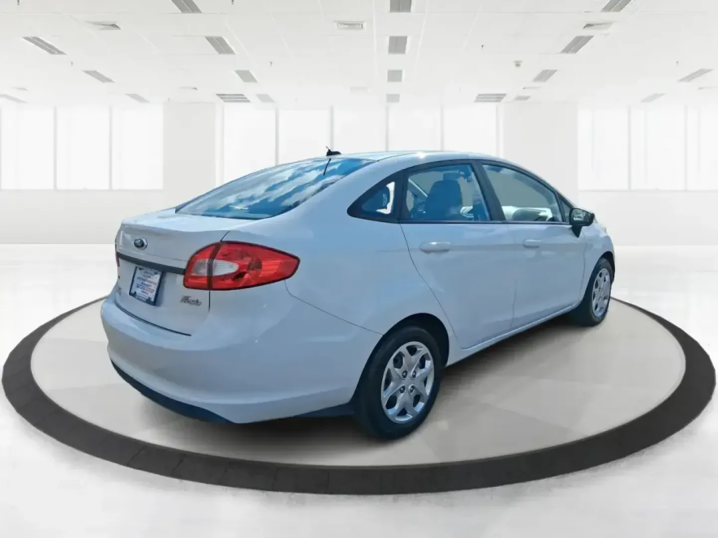 2013 Ford Fiesta SE (3FADP4BJXDM) with an 1.6L I-4 DOHC engine, located at 1951 S Dayton Lakeview Rd., New Carlisle, OH, 45344, (937) 908-9800, 39.890999, -84.050255 - Need a smart, efficient commuter that's easy to park downtown, nimble on I70, and still comfortable for weekend errands or a quick getaway to Springfield or Dayton? This 2013 Ford Fiesta SE Sedan in Oxford White delivers practical daily driving with the kind of budget-friendly ownership that fits re - Photo#2