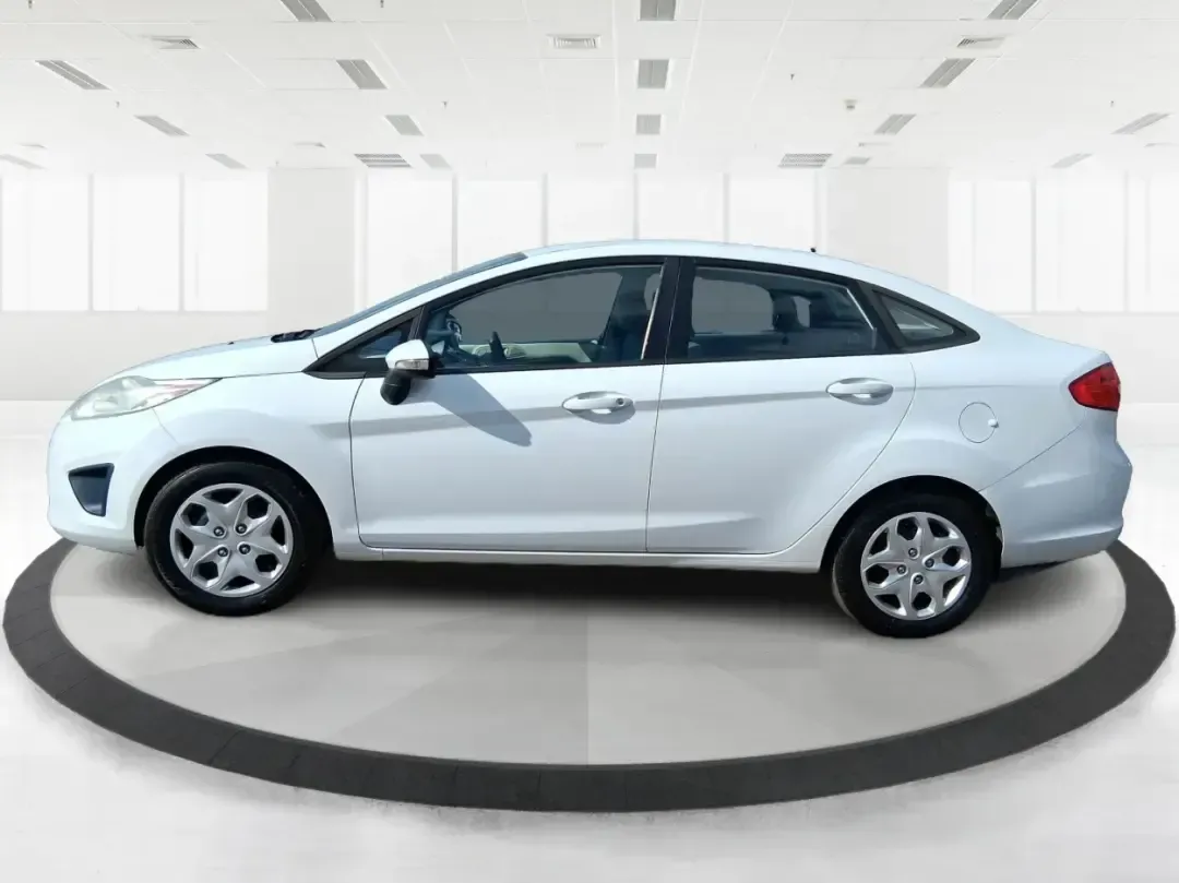 2013 Ford Fiesta SE (3FADP4BJXDM) with an 1.6L I-4 DOHC engine, located at 1951 S Dayton Lakeview Rd., New Carlisle, OH, 45344, (937) 908-9800, 39.890999, -84.050255 - Need a smart, efficient commuter that's easy to park downtown, nimble on I70, and still comfortable for weekend errands or a quick getaway to Springfield or Dayton? This 2013 Ford Fiesta SE Sedan in Oxford White delivers practical daily driving with the kind of budget-friendly ownership that fits re - Photo#5