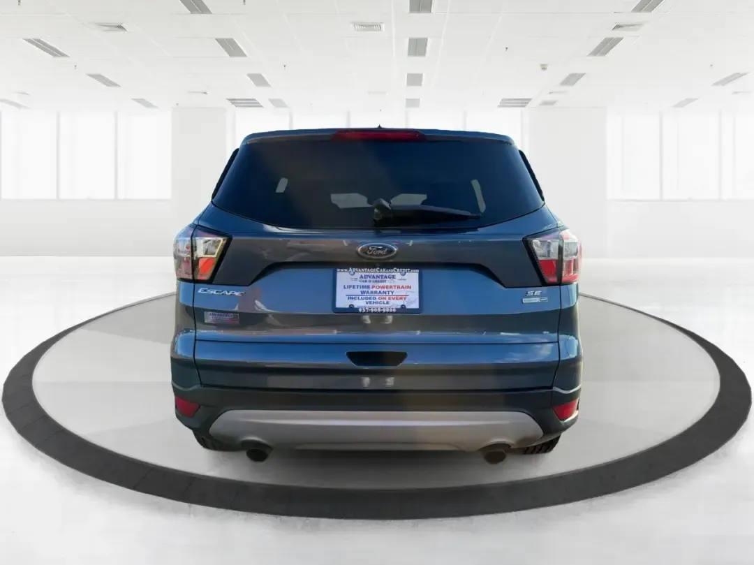 2018 Ford Escape SE (1FMCU9GD4JU) with an 1.5L L4 DOHC 16V engine, 6A transmission, located at 880 E. National Road, Vandalia, OH, 45377, (937) 908-9800, 39.891918, -84.183594 - Picture your next Ohio weekend: loading up the kids for a splash at Splash Xenia, cruising out to John Bryan State Park for a hike, or tackling a snowy morning commute from Beavercreek to downtown Dayton with confidence. This 2018 Ford Escape SE in Blue Metallic is the kind of compact SUV that fits - Photo#3