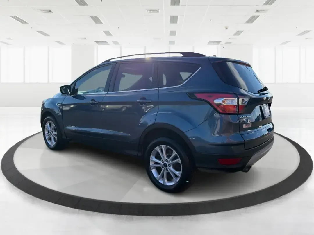 2018 Ford Escape SE (1FMCU9GD4JU) with an 1.5L L4 DOHC 16V engine, 6A transmission, located at 880 E. National Road, Vandalia, OH, 45377, (937) 908-9800, 39.891918, -84.183594 - Picture your next Ohio weekend: loading up the kids for a splash at Splash Xenia, cruising out to John Bryan State Park for a hike, or tackling a snowy morning commute from Beavercreek to downtown Dayton with confidence. This 2018 Ford Escape SE in Blue Metallic is the kind of compact SUV that fits - Photo#4