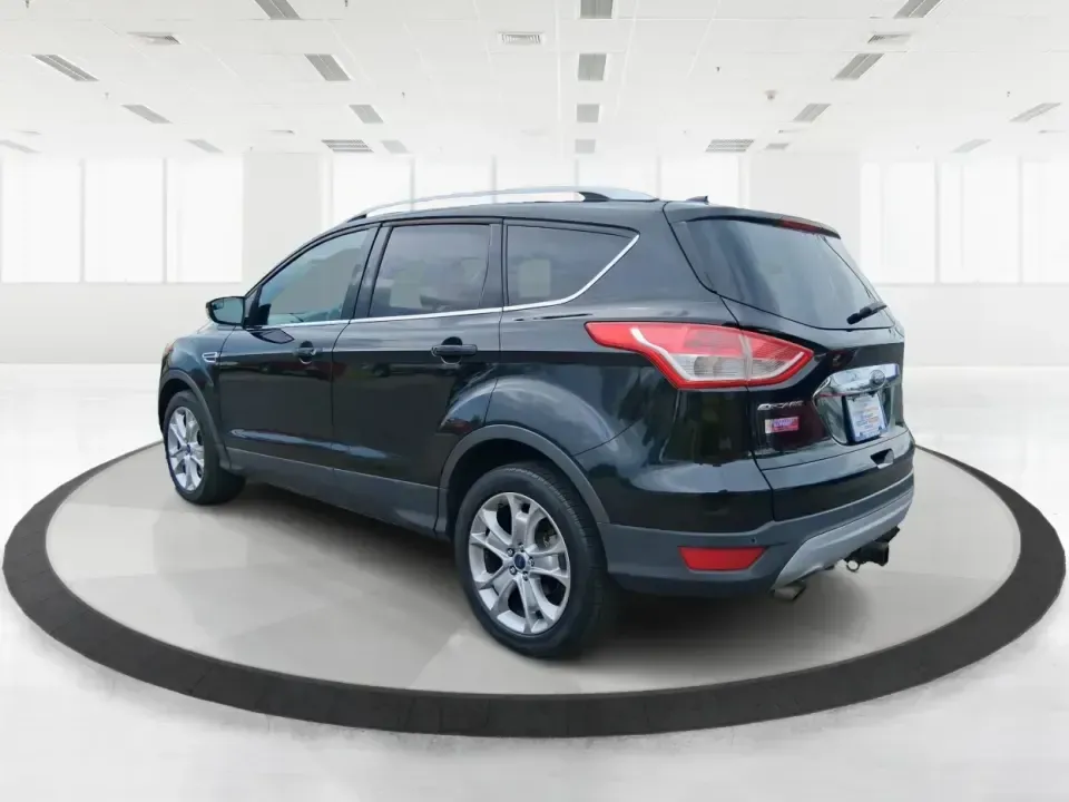 2014 Ford Escape Titanium (1FMCU9J99EU) with an 2.0L L4 DOHC 16V engine, 6-Speed Automatic transmission, located at 1099 N County Rd 25A, Troy, OH, 45373, (937) 908-9800, 40.057079, -84.212883 - Need one SUV that can handle an Ohio winter commute, school drop-offs, and a spontaneous weekend road trip to Hocking Hills without feeling like a compromise? This 2014 Ford Escape Titanium 4WD in sleek Tuxedo Black is built for real life in Troy-comfortable for long drives, confident in bad weather - Photo#4