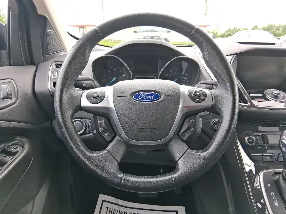 2014 Ford Escape Titanium (1FMCU9J99EU) with an 2.0L L4 DOHC 16V engine, 6-Speed Automatic transmission, located at 1099 N County Rd 25A, Troy, OH, 45373, (937) 908-9800, 40.057079, -84.212883 - Need one SUV that can handle an Ohio winter commute, school drop-offs, and a spontaneous weekend road trip to Hocking Hills without feeling like a compromise? This 2014 Ford Escape Titanium 4WD in sleek Tuxedo Black is built for real life in Troy-comfortable for long drives, confident in bad weather - Photo#16