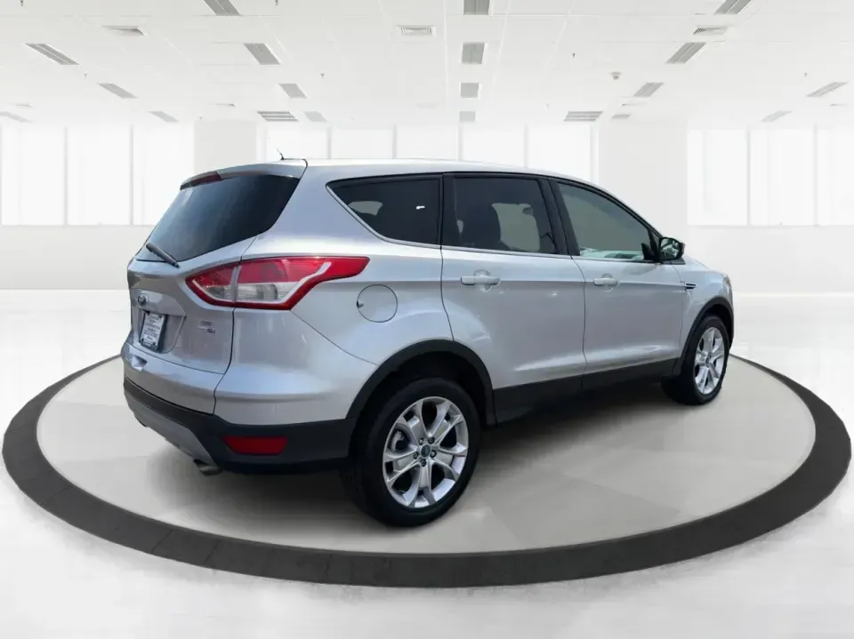 2015 Ford Escape SE (1FMCU9G98FU) with an 2.0L L4 DOHC 16V engine, 6-Speed Automatic transmission, located at 1099 N County Rd 25A, Troy, OH, 45373, (937) 908-9800, 40.057079, -84.212883 - Weekday commutes down I75, school drop-offs around Troy City Schools, and spontaneous weekend trips to Charleston Falls Preserve all get easier when you have an SUV that's the right size, the right power, and the right fit for your budget. This 2015 Ford Escape SE in Ingot Silver is built for real-l - Photo#2