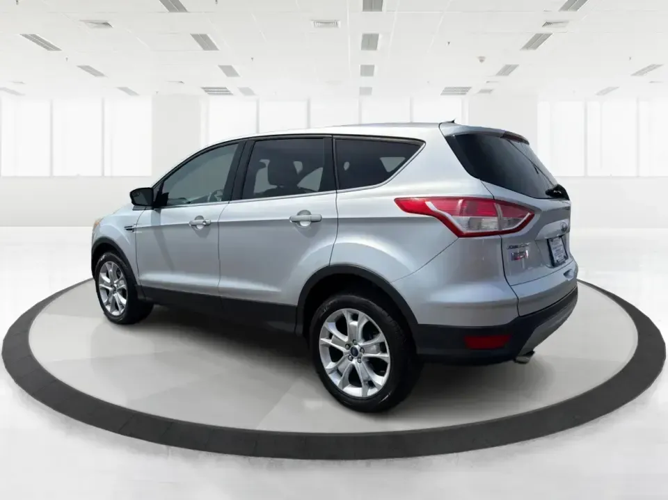 2015 Ford Escape SE (1FMCU9G98FU) with an 2.0L L4 DOHC 16V engine, 6-Speed Automatic transmission, located at 1099 N County Rd 25A, Troy, OH, 45373, (937) 908-9800, 40.057079, -84.212883 - Weekday commutes down I75, school drop-offs around Troy City Schools, and spontaneous weekend trips to Charleston Falls Preserve all get easier when you have an SUV that's the right size, the right power, and the right fit for your budget. This 2015 Ford Escape SE in Ingot Silver is built for real-l - Photo#4